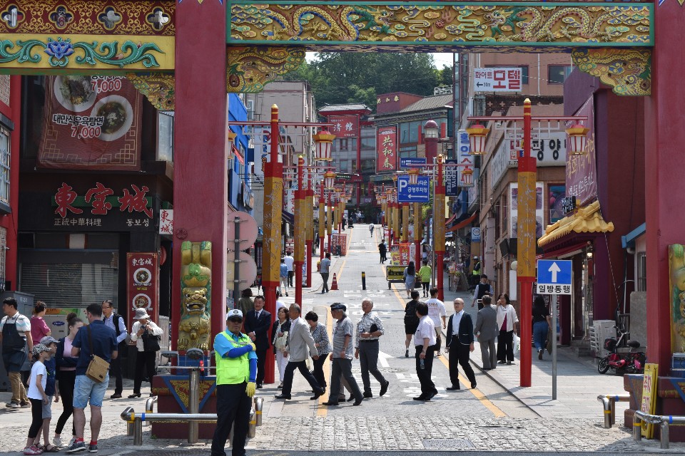 A photo of China street in Incheon chinatown. in the background people are walking up the street.